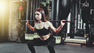 Woman squat with stick