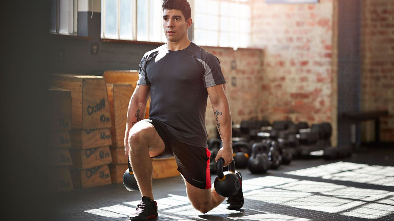 Man doing lunge holding weights.