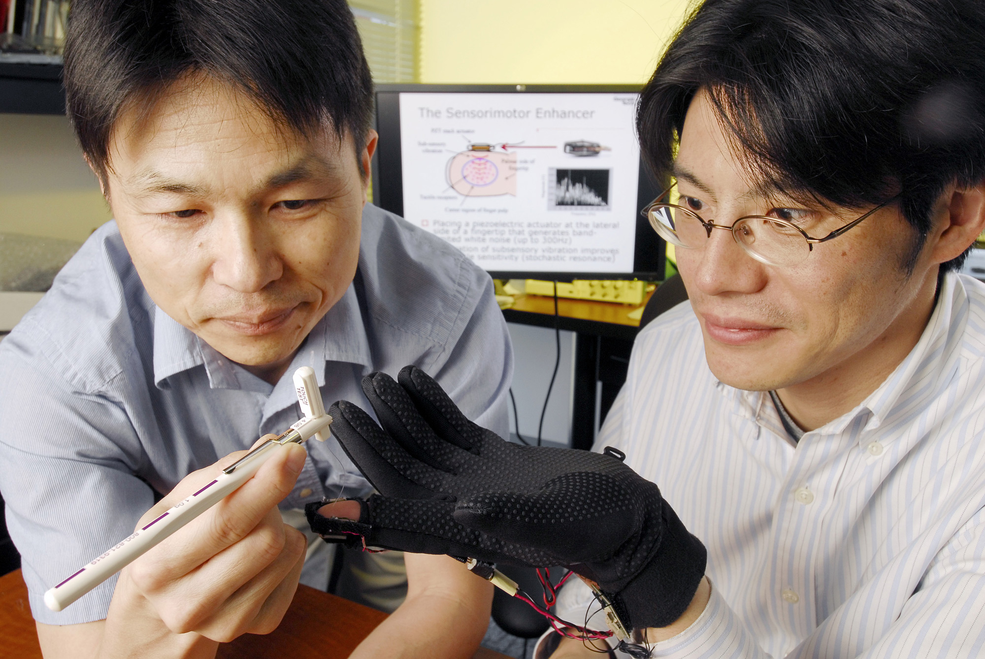 Professor Minoru Shinohara tests vibrating glove.