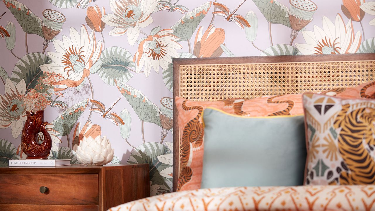 bedroom with large tropical pattern wallpaper and wooden bed