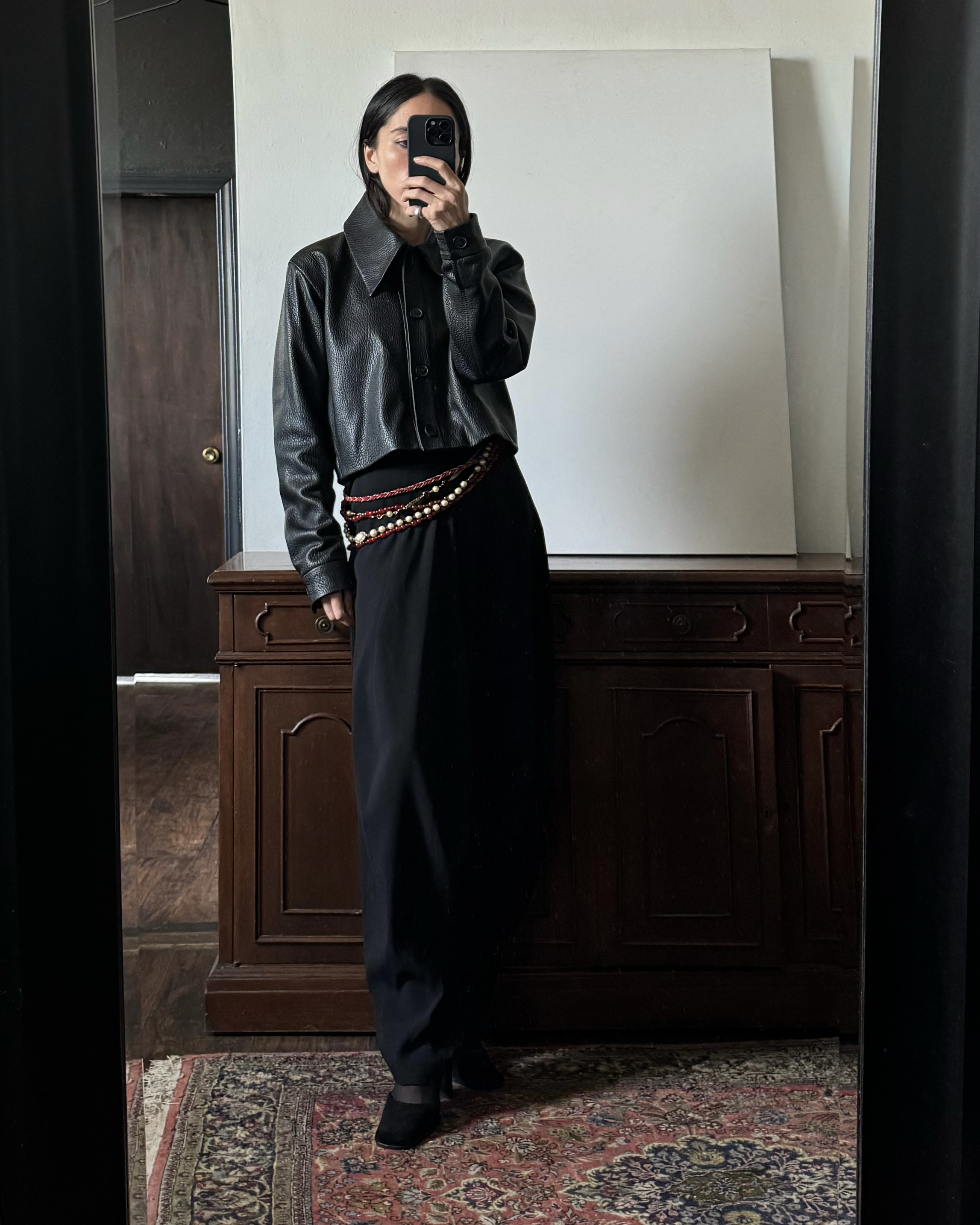 Alexis Badiyi wearing a leather jacket and pants