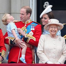 Prince George of Cambridge is held by Prince William, Duke of Cambridge and Catherine, Duchess of Cambridge, Prince Charles, Prince of Wales and Queen Elizabeth II look out on the balcony of uckingham Palace during the Trooping the Colour on June 13, 2015 in London, England