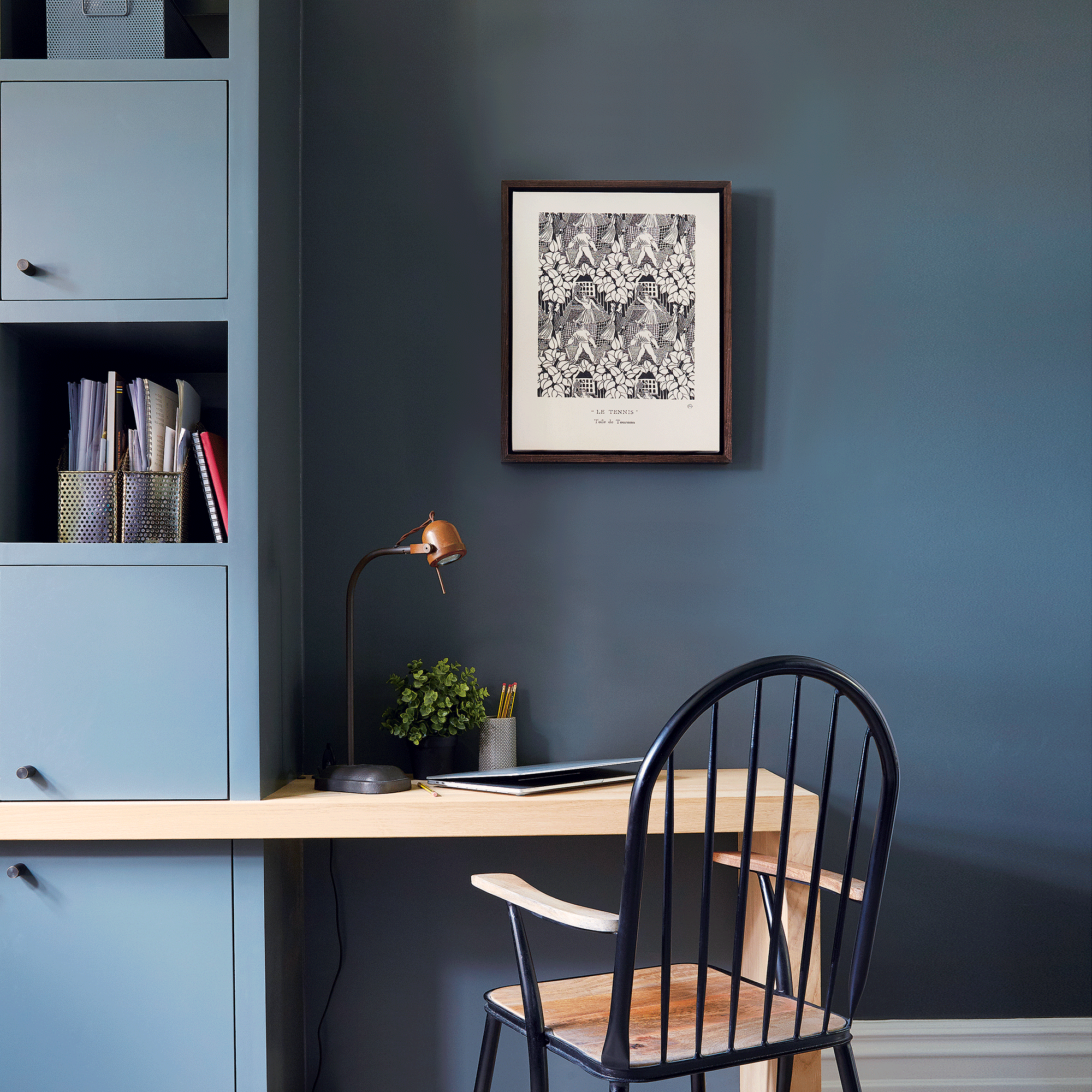 Blue walls and cabinet with small desk