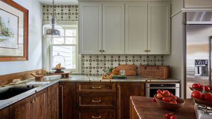 A Nora Ephron-inspired kitchen with wooden cabinets and collected decor