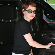 Emma Stone arrived at the Venice Film Festival in the toe-ring sandal trend and two Louis Vuitton bags