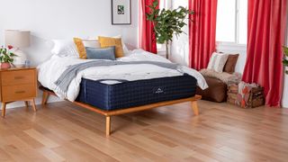 DreamCloud Mattress Review lead image, featuring a DreamCloud Mattress with sheets and pillows on top