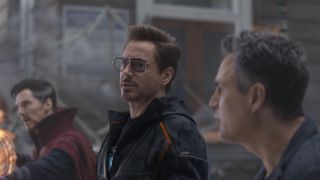 Tony Stark speaking to Bruce Banner as Doctor Strange stands nearby