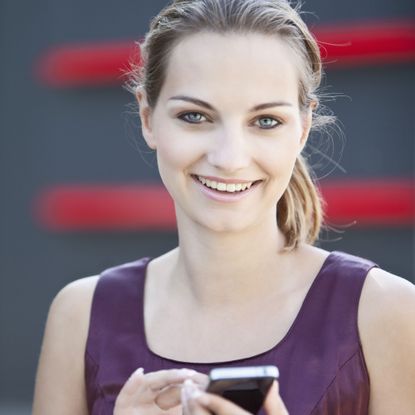 blonde woman looking at a smartphone
