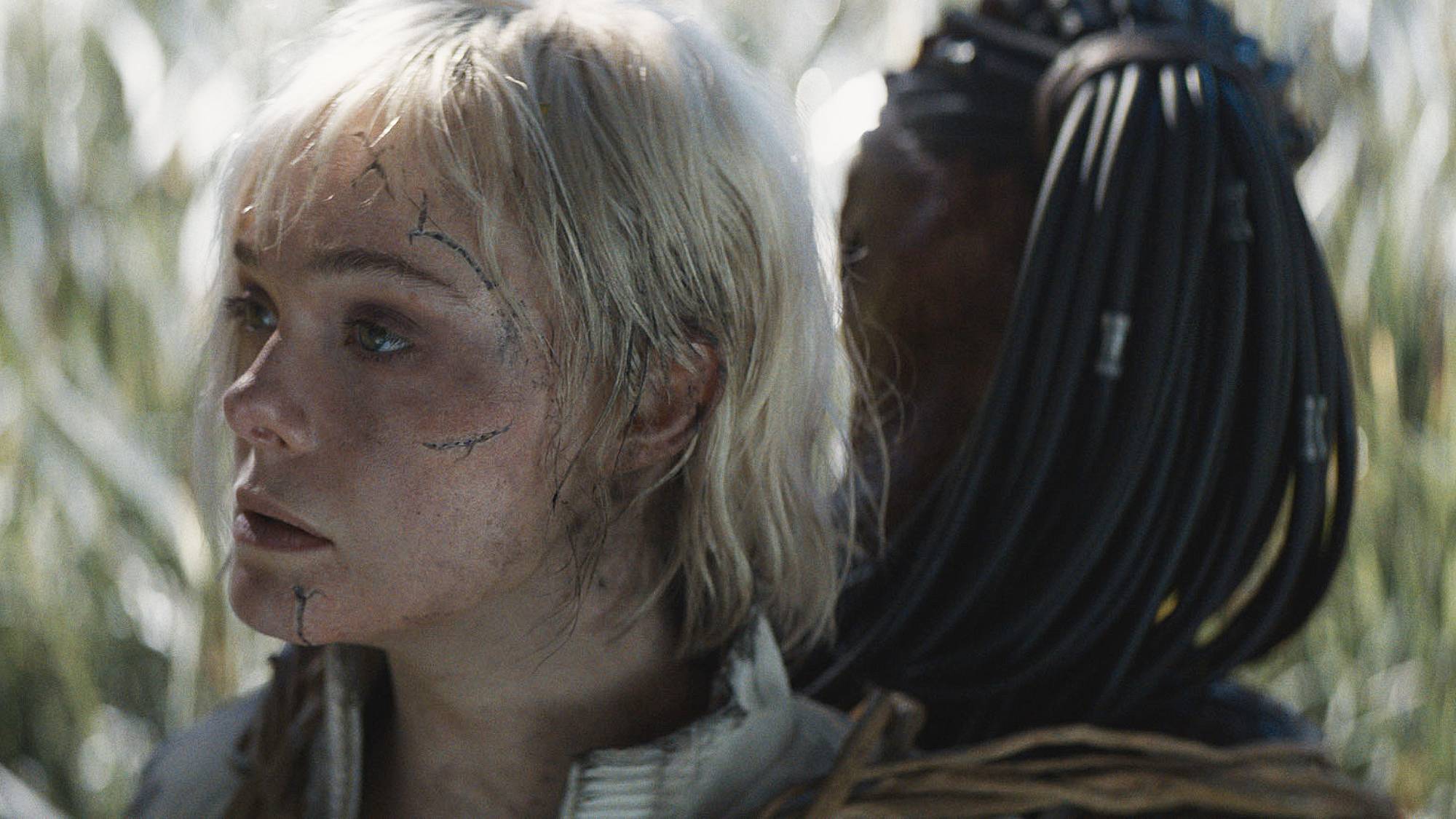 Elle Fanning as Thia and Dimitrius Schuster-Koloamatangi as Dek in &quot;Predator: Badlands&quot;