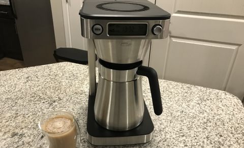 OXO 12-Cup Coffee Maker next to a drink on kichen countertop