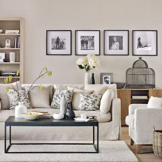 Cream living room with line of smart framed prints and black accents