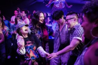 kelly marie tran lily gladstone bowen yang and Han Gi-chan dance at a bar in the movie the wedding banquet