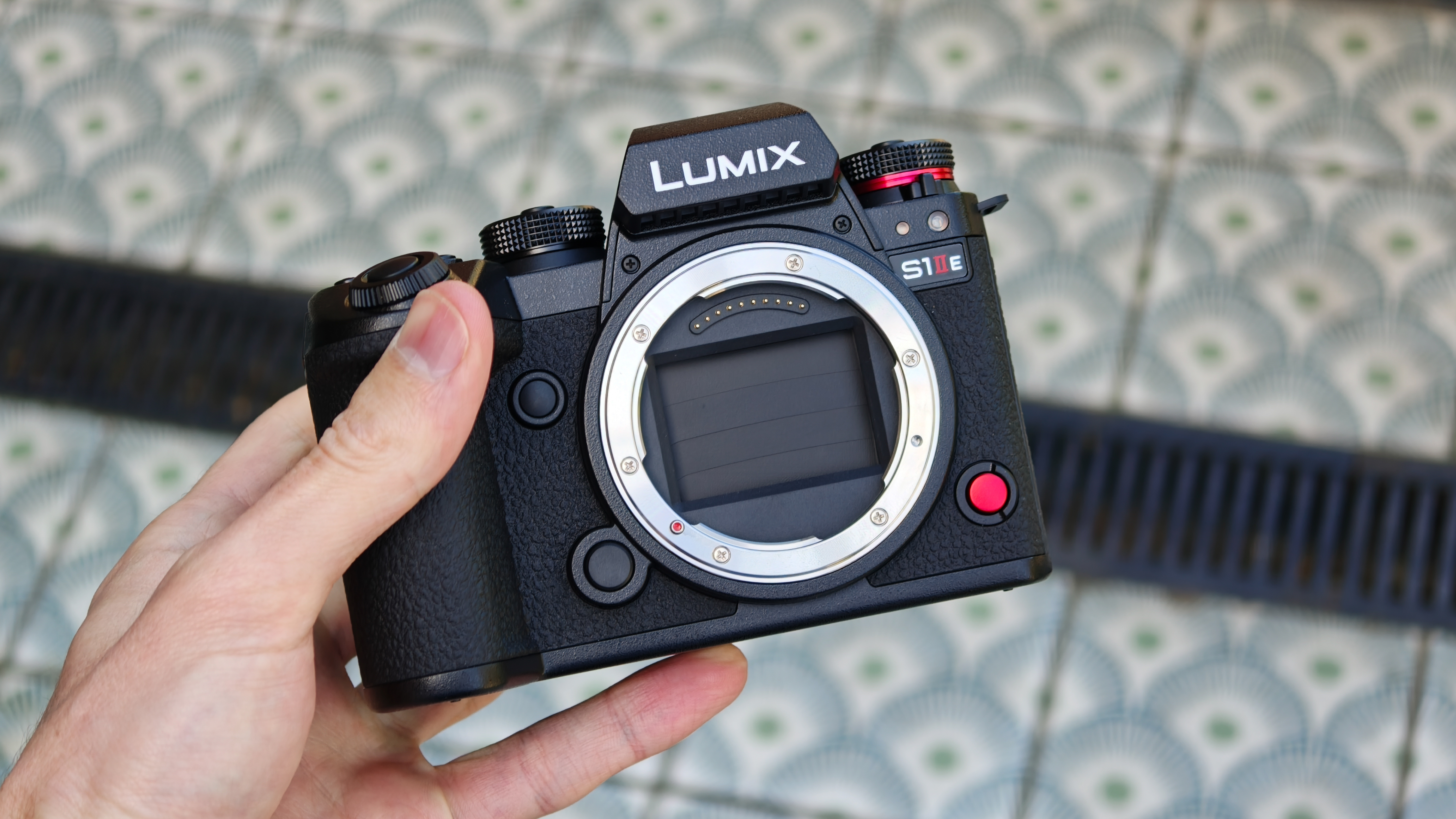 Panasonic Lumix S1IIE camera held in a hand