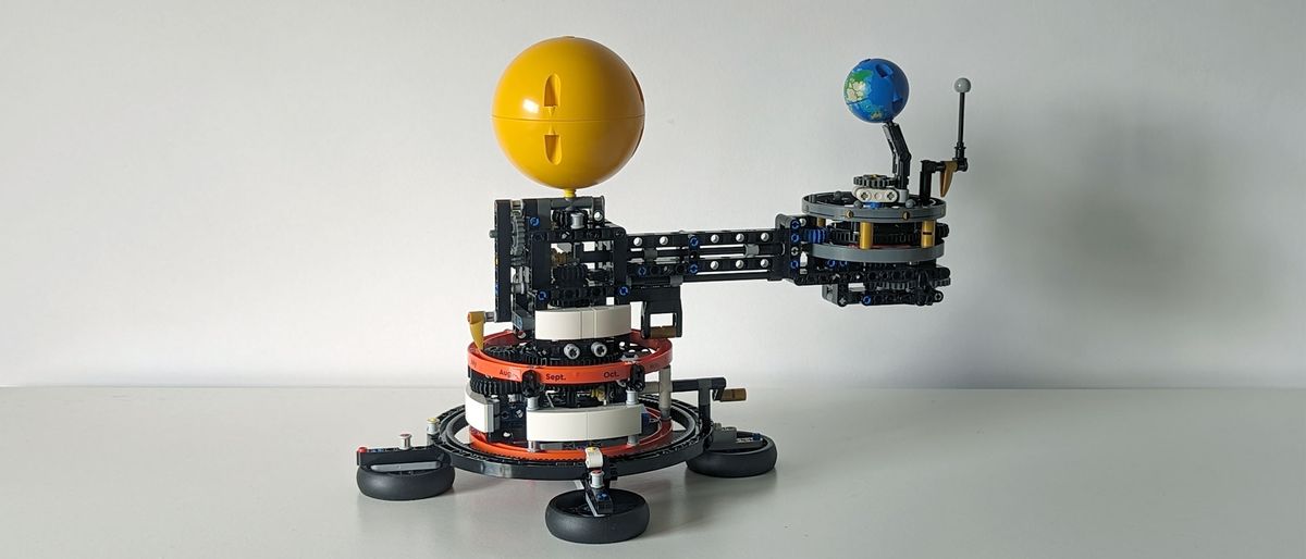 Lego technic planet earth and moon in orbit set on a white background