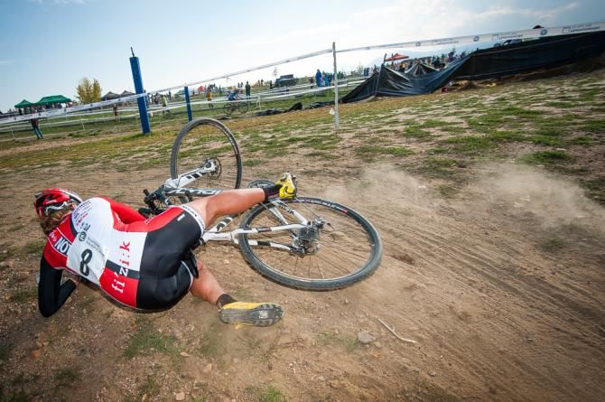 A rider takes a fall on loose sandy corner. Colorado Cross Classic.