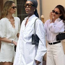 White outfit ideas for summer are showcased in a collage of photos featuring women wearing white clothing outdoors. On the left, a woman is wearing a white puff-sleeve tie-up blouse with matching shorts, a brown bag, and brown sunglasses. In the middle, a woman is wearing a headscarf with aviator sunglasses, a white shirt dress, and a black shoulder bag. On the right, a woman is wearing black sunglasses, a white button-down shirt, a black belt, white jeans, and a black shoulder bag.