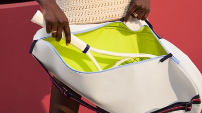 woman with tennis racket bag