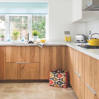 Kitchen with a tiled floor and wooden cabinets