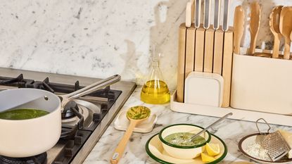 Cream kitchen tools on white marble counter