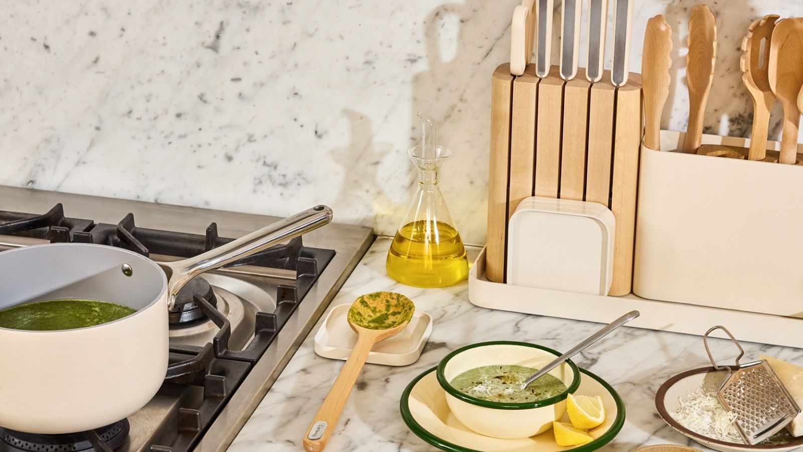 Cream kitchen tools on white marble counter