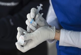 A nurse fills a syringe with COVID-19 vaccine in Reading, Pennsylvania.