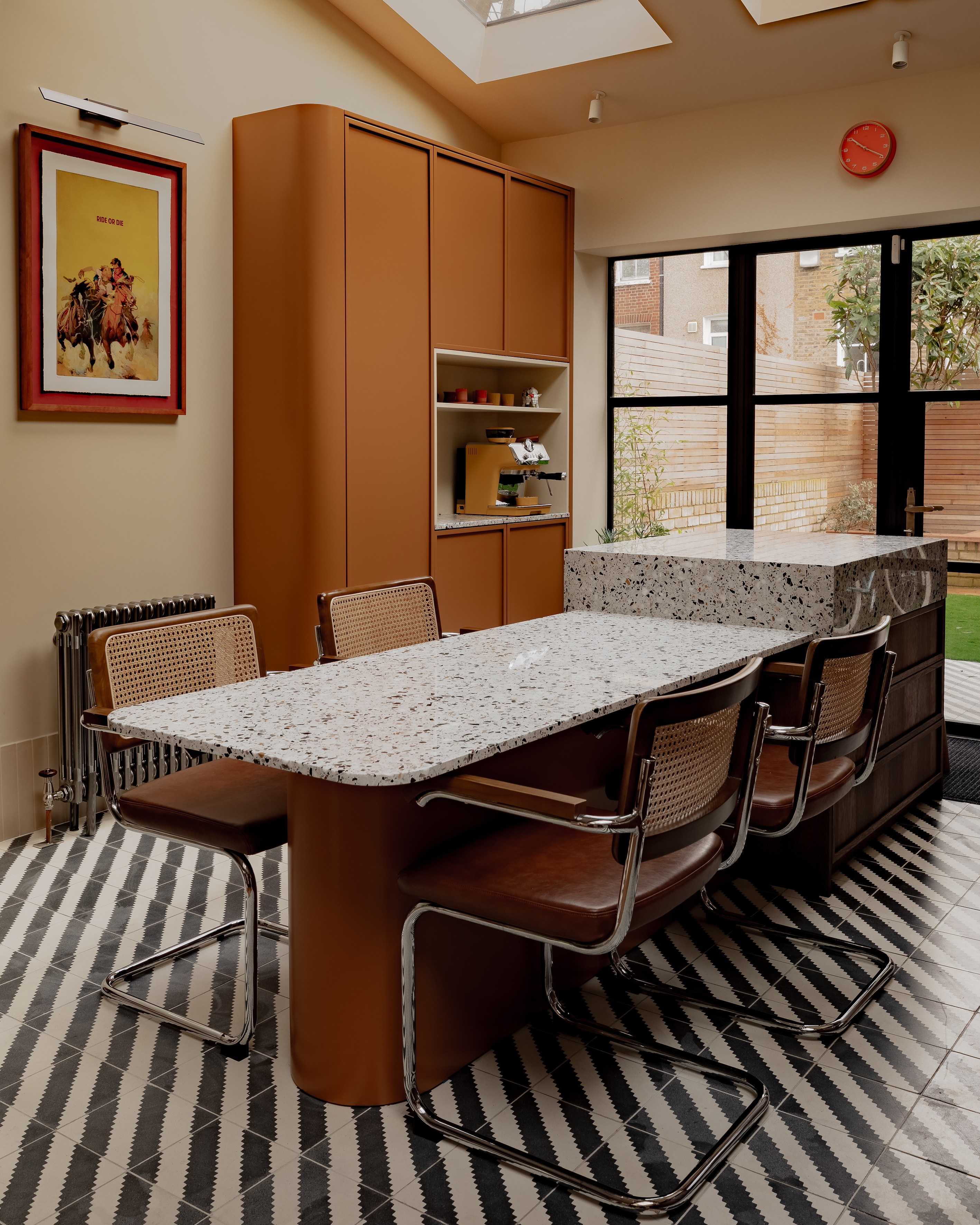 blue and white striped flooring in a modern kitchen with mid-century chairs