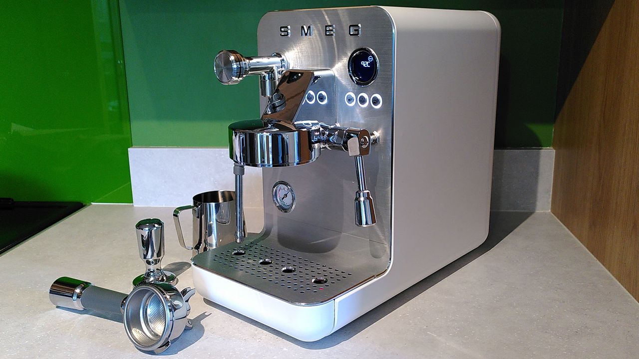 Smeg Mini Pro Espresso Coffee Machine with milk pitcher and portafilter on kitchen counter