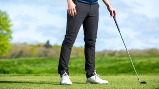 A golfer poses in a blue pair of Abacus Mellion Stretch Pants