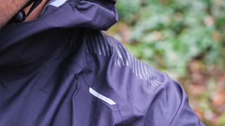 A rider's shoulder in a waterproof jacket
