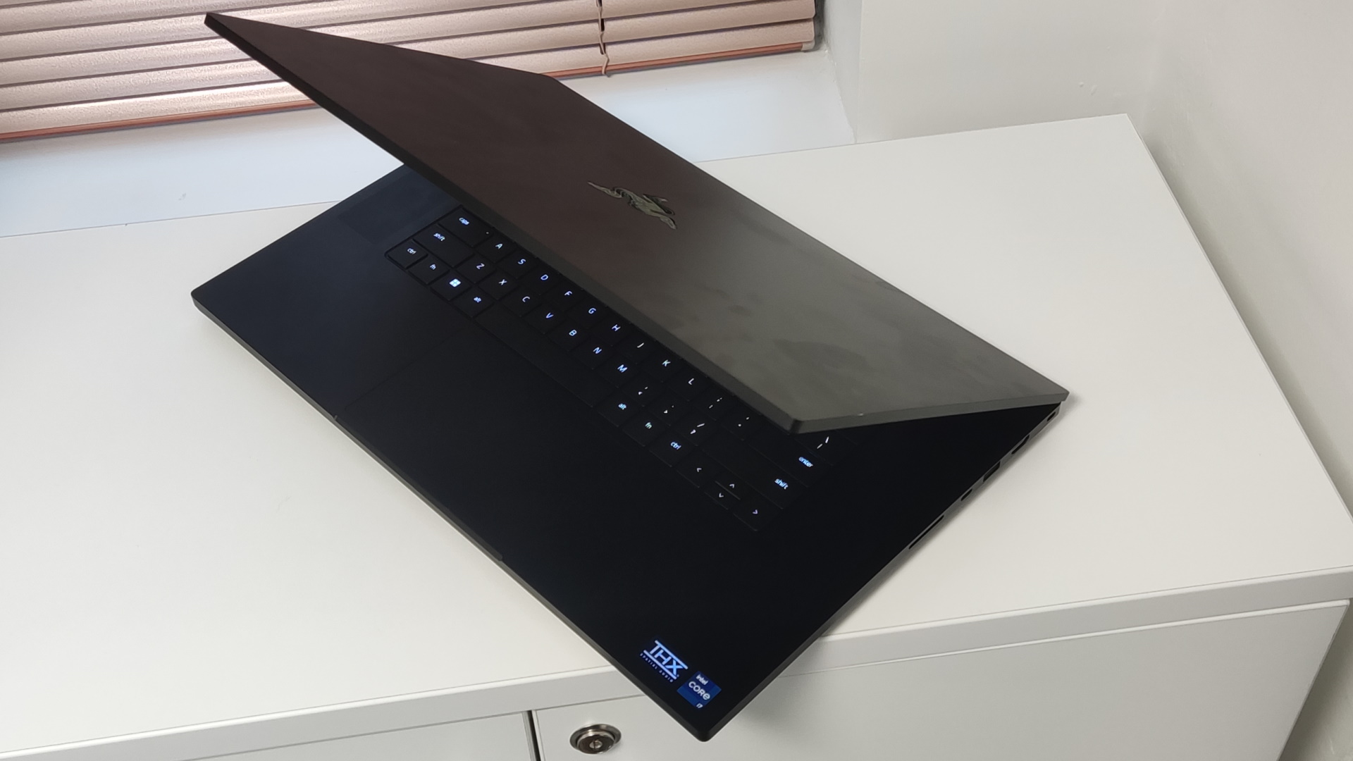 Image of Razer Blade 17 by a window.