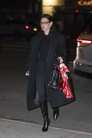 bella hadid is seen in new york city on december 12 wearing a long duster coat and jeans with a croc embosses sac de jour tote bag from saint laurent