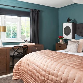 teal bedroom with study table and grey curtains