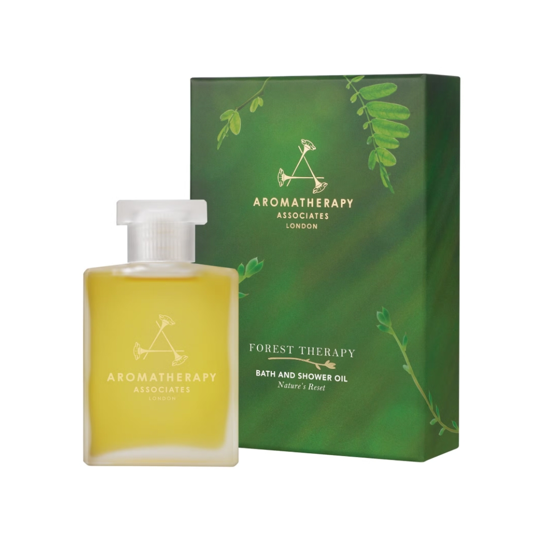 A product shot of the Aromatherapy Associates Forest Therapy Bath &amp;amp; Shower Oil, alongside its green box, on a white background