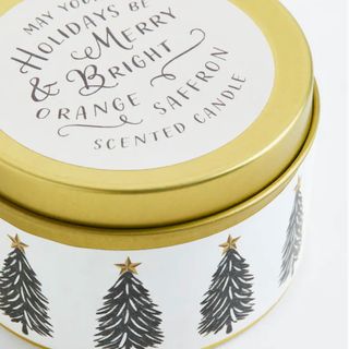 Gold tin candle with xmas tree label