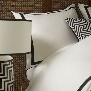 black and white duvet cover set on rattan bed
