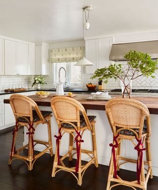 kitchen with white units and rattan stools
