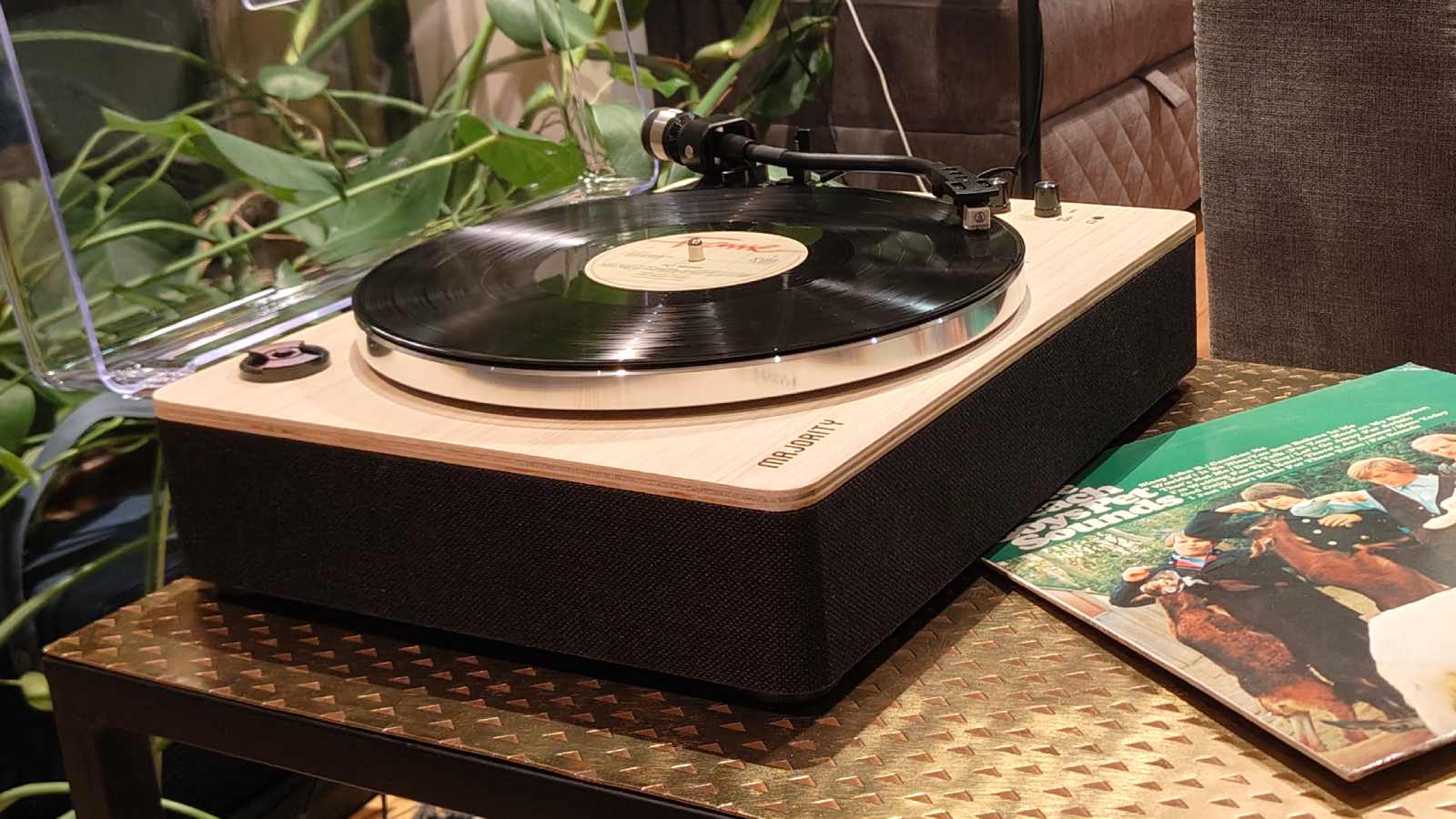 The Majority Folio on a bronze table with plants in the background.
