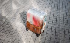 Palace Rimowa suitcase with airbrushed print photographed on tiled floor