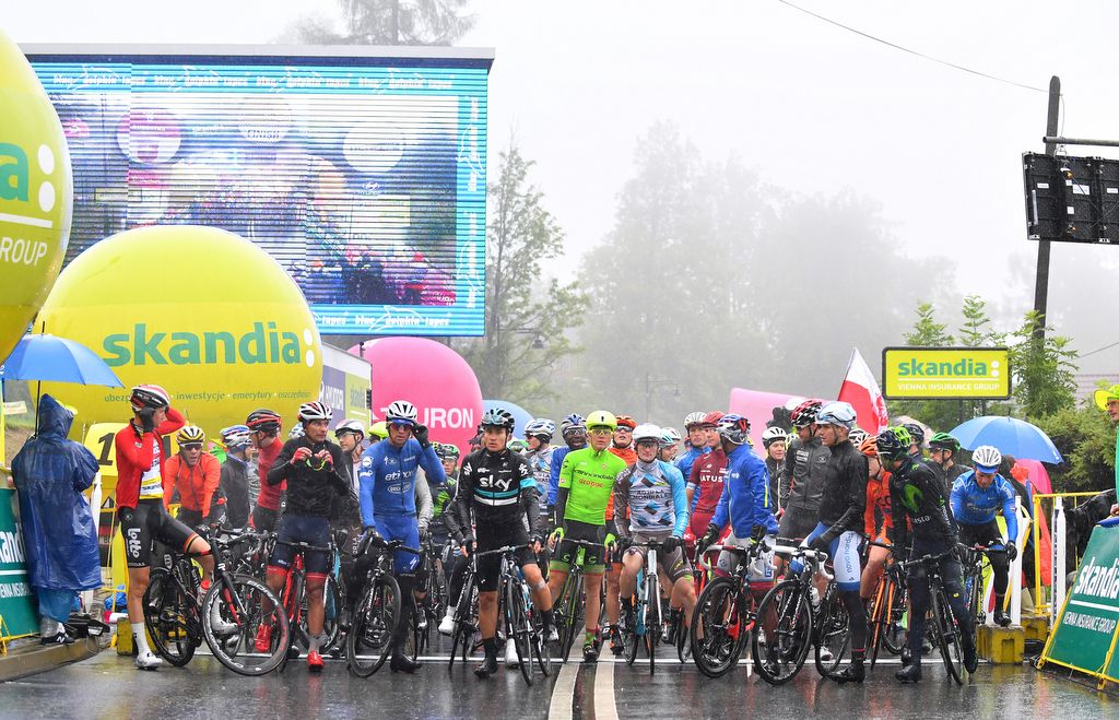 The riders await the start of the stage which would eventually be cancelled due to the weather