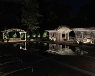 pool lighting on buildings and structures around a garden pool