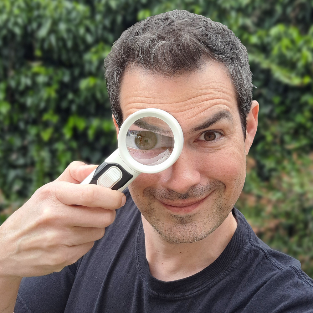 expert Tim Boomer with a magnifying glass