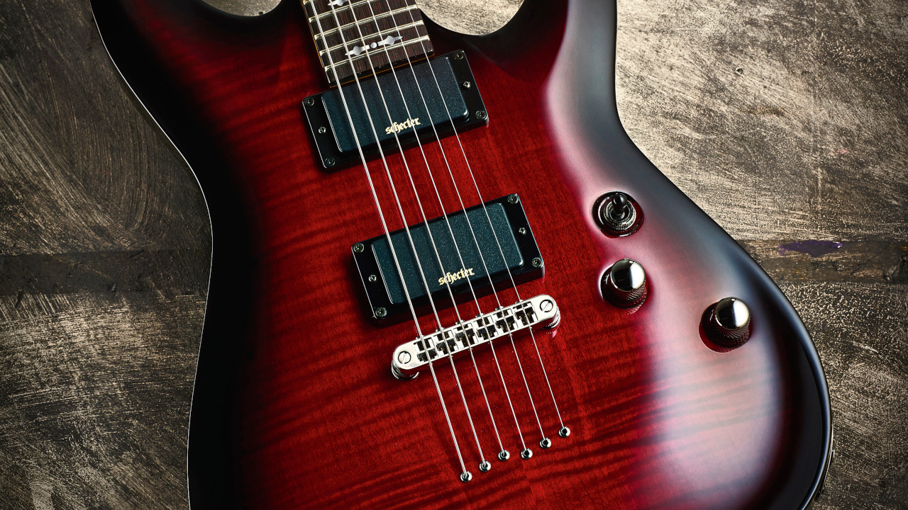 The Schecter Demon-6 electric guitar on a wooden floor