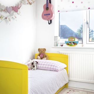 children bedroom with yellow bed and polka dots bedsheet