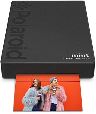 Black Polaroid Mint Pocket Printer printing out photo product shot