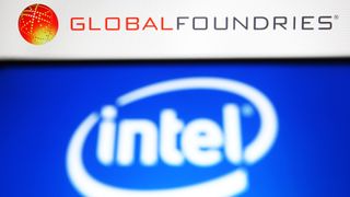 In this photo illustration, Intel logo is seen on a smartphone screen and GlobalFoundries (GF) logo of a semiconductor manufacturing company in the background.