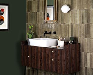 Mink tiled wall with mirror and brown bathroom storage unit by Walls and Floors