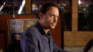 Timothy McGee sitting at his bullpen desk in NCIS