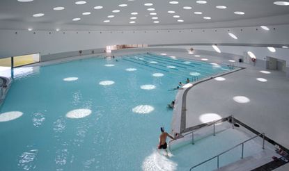 Indoor swimming pool with white roof with round lights