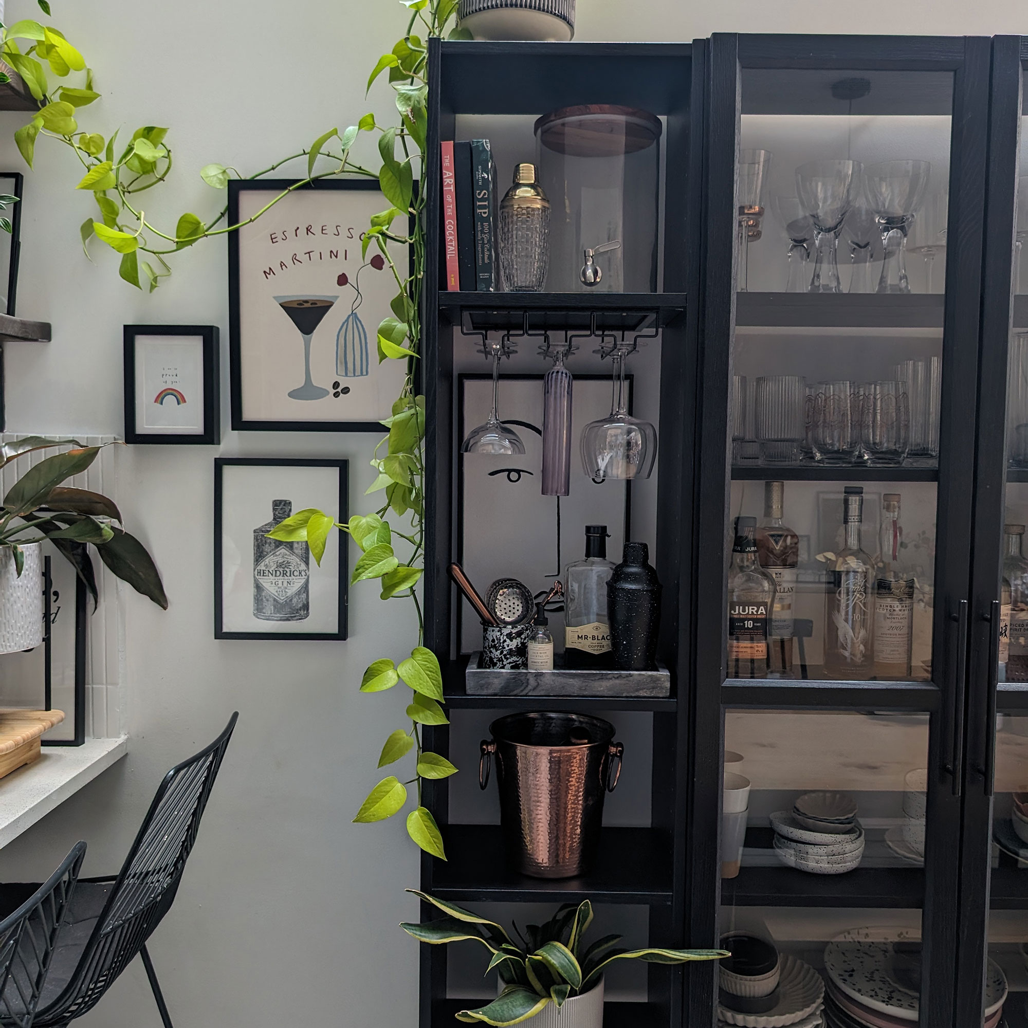 Glass-fronted cabinet with glasses, champagne bucket and various bar items