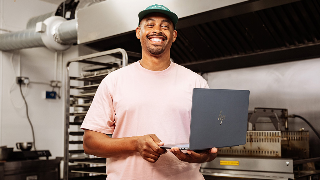 Bakery founder holds a HP Omnibook Ultra with Snapdragon X2 Elite